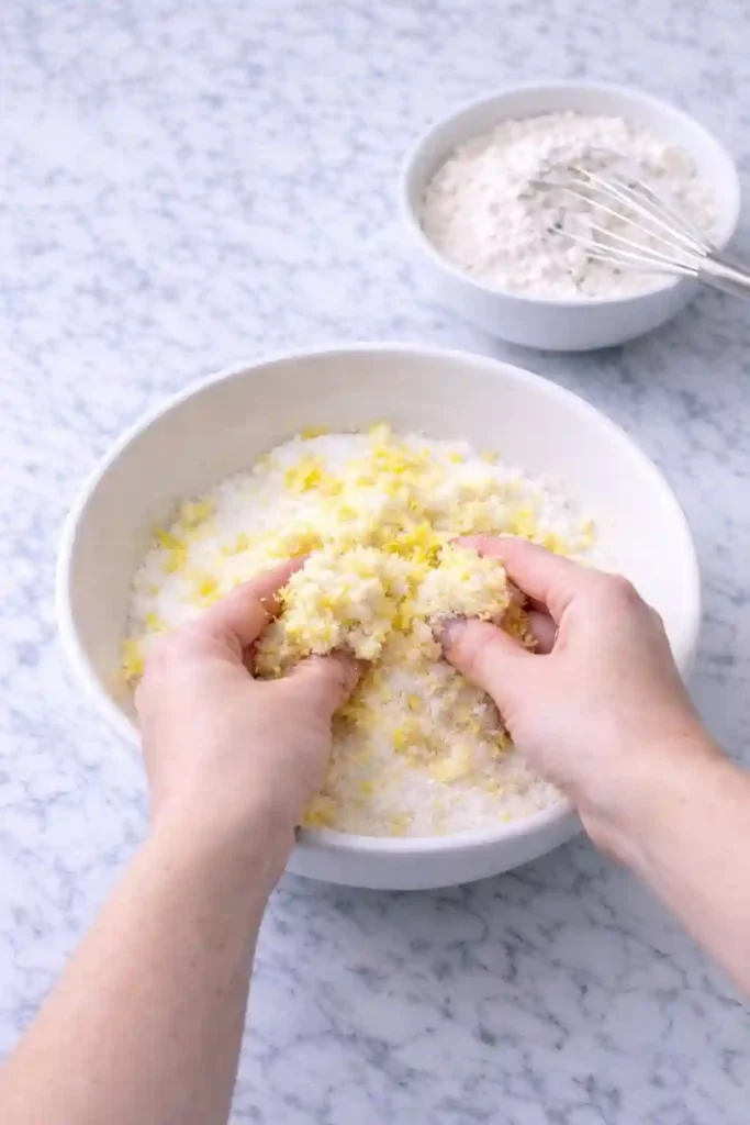 Lemon zest rubbed into sugar beside flour mixture for pound cake