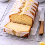 Sliced lemon pound cake with set glaze and buttery crumb